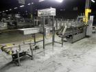 Used Combi Packaging Systems Model DPI Drop Case Packer. Has a model 2LD128 laner option. Capable of speeds up to 28 cases per minute. Has a case size range: (length) 4.5