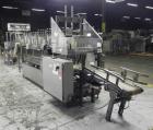 Used Combi Packaging Systems Model DPI Drop Case Packer. Has a model 2LD128 laner option. Capable of speeds up to 28 cases per minute. Has a case size range: (length) 4.5