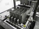 Used Combi Packaging Systems Model DPI Drop Case Packer. Has a model 2LD128 laner option. Capable of speeds up to 28 cases per minute. Has a case size range: (length) 4.5