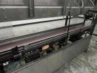 Used Combi Packaging Systems Model DPI Drop Case Packer. Has a model 2LD128 laner option. Capable of speeds up to 28 cases per minute. Has a case size range: (length) 4.5