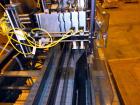 Used Hartness 825-AT automatic stainless steel drop case packer case packer capable of speeds up to 35 cases per minute (depending on product and application). Case size range: (Length) 6