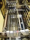 Used Hartness Case Packer with Infeed Laner, Model CP900/825. Servo controlled lowering head drop packer capable of speeds up to 30cpm. Allen Bradley SLC 5/04 PLC with Pacific Scientific servo contro...