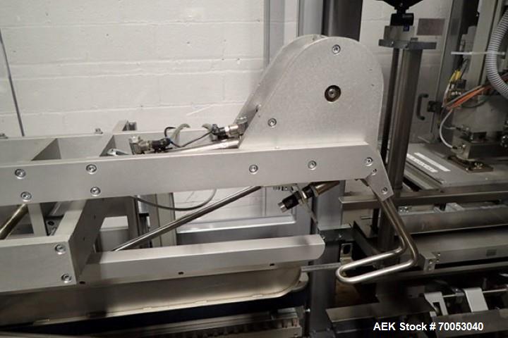 Used Skinetta Top Loading Case Erector Packer, Model CP 150. Servo driven loading head, with powered case feeder and case erector. Integrated top and bottom case taper. Includes controls. 3/60/480 Vo...