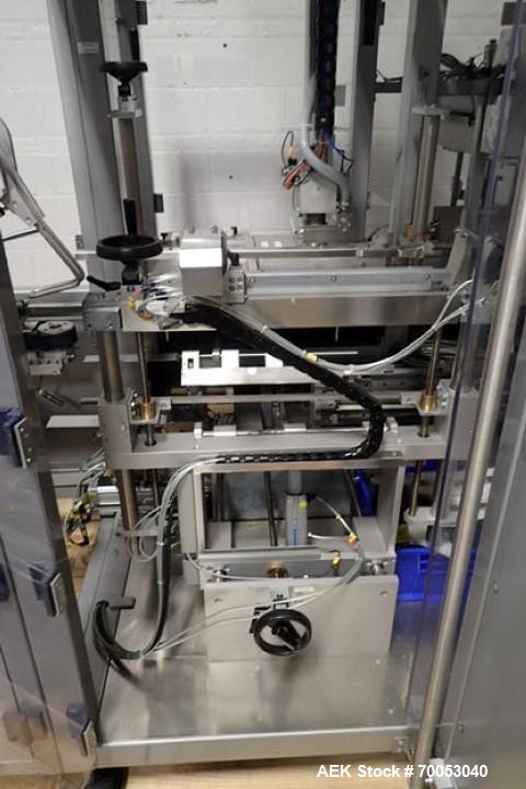 Used Skinetta Top Loading Case Erector Packer, Model CP 150. Servo driven loading head, with powered case feeder and case erector. Integrated top and bottom case taper. Includes controls. 3/60/480 Vo...