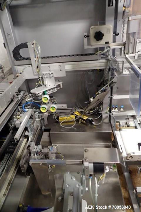 Used Skinetta Top Loading Case Erector Packer, Model CP 150. Servo driven loading head, with powered case feeder and case erector. Integrated top and bottom case taper. Includes controls. 3/60/480 Vo...