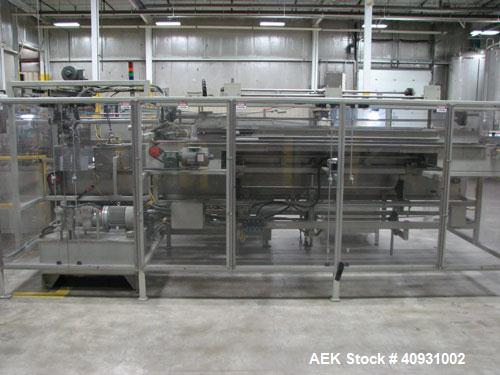 Used Smurfit-Stone Packomatic Model 1588 Case Former and Packer. New 2002. Up to 25 cases per hour, maximum case size 24" long x 16" wide x 20" deep, Nordson series 3500V gluer.