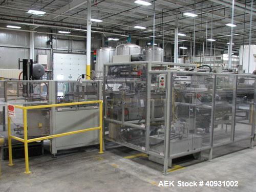 Used Smurfit-Stone Packomatic Model 1588 Case Former and Packer. New 2002. Up to 25 cases per hour, maximum case size 24" long x 16" wide x 20" deep, Nordson series 3500V gluer.