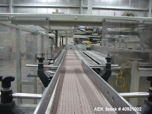 Used Smurfit-Stone Packomatic Model 1588 Case Former and Packer. New 2002. Up to 25 cases per hour, maximum case size 24" long x 16" wide x 20" deep, Nordson series 3500V gluer.