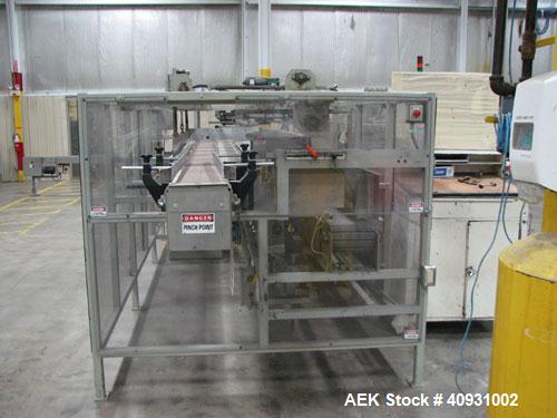 Used Smurfit-Stone Packomatic Model 1588 Case Former and Packer. New 2002. Up to 25 cases per hour, maximum case size 24" long x 16" wide x 20" deep, Nordson series 3500V gluer.