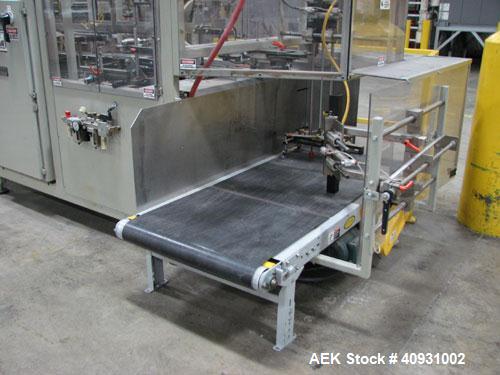 Used Smurfit-Stone Packomatic Model 1588 Case Former and Packer. New 2002. Up to 25 cases per hour, maximum case size 24" long x 16" wide x 20" deep, Nordson series 3500V gluer.