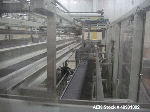 Used Smurfit-Stone Packomatic Model 1588 Case Former and Packer. New 2002. Up to 25 cases per hour, maximum case size 24" long x 16" wide x 20" deep, Nordson series 3500V gluer.