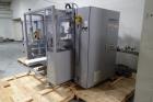 Used Skinetta Top Loading Case Erector Packer, Model CP 150. Servo driven loading head, with powered case feeder and case erector. Integrated top and bottom case taper. Includes controls. 3/60/480 Vo...
