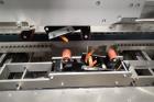 Used Skinetta Top Loading Case Erector Packer, Model CP 150. Servo driven loading head, with powered case feeder and case erector. Integrated top and bottom case taper. Includes controls. 3/60/480 Vo...