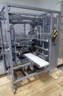 Used Skinetta Top Loading Case Erector Packer, Model CP 150. Servo driven loading head, with powered case feeder and case erector. Integrated top and bottom case taper. Includes controls. 3/60/480 Vo...