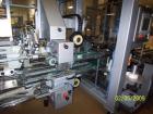 Used Cermex Sidel model SD59 top loading case packer capable of speeds up to 28 case per minute. Has automatic collation, AB PLC controls, tape seal system.