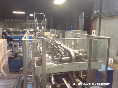 Used Douglas Case Packer, Model M-3409. 28-30 cases per minute, 128 oz. can/94 oz. can.