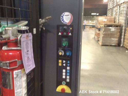 Used Douglas Case Packer, Model M-3409. 28-30 cases per minute, 128 oz. can/94 oz. can.