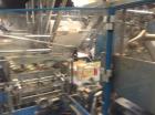 Used Douglas Case Packer, Model M-3409. 28-30 cases per minute, 128 oz. can/94 oz. can.