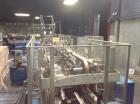 Used Douglas Case Packer, Model M-3409. 28-30 cases per minute, 128 oz. can/94 oz. can.