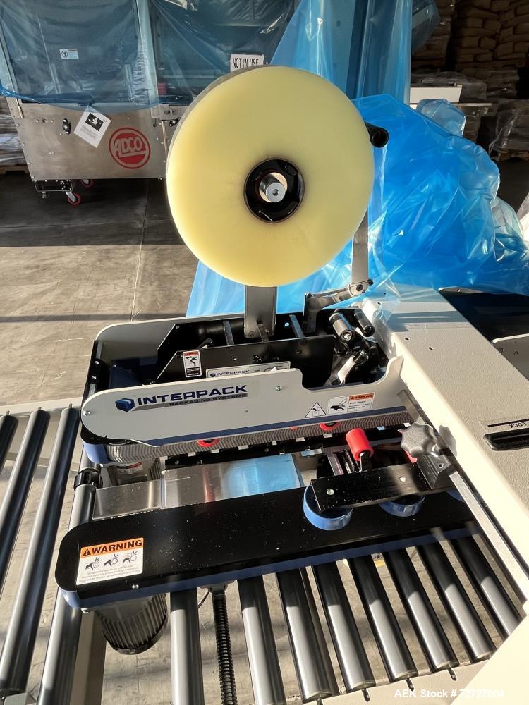Used Interpack Top and Bottom Tape Case Sealer, Model USA20-SB-BO. Belt speed 82 feet per minute. Carton weight capacity up to 85lbs. Interpack HSD 2000-ET II standard tape head. Serial# TM 094 18B 0...