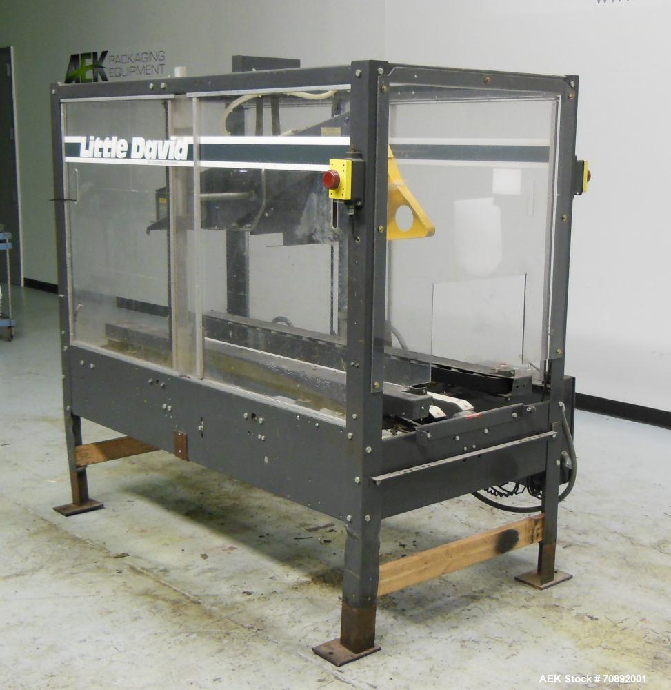 Used Loveshaw Little David Model LD16A Top and Bottom Automatic Case Sealer. Missing (1) tape head. Capable of speeds up to 60 feet per minute or 14 cases per minute. Case size range: (length) 8-1/2"...