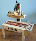Used Belcor (Wexxar) Model 185 automatic random top case taper sealer. Capable of speeds up to 20 cases per minute. Has a case size range: 8