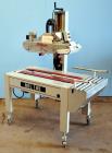 Used Belcor (Wexxar) Model 185 automatic random top case taper sealer. Capable of speeds up to 20 cases per minute. Has a case size range: 8