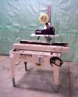 Used Bemis Semi-Automatic Uniform Top /Bottom Case Taper, Model 1018SA, carbon steel. Capable of speeds up to 28 CPM. Has side belt transfers and a case size range: length 4-1/2