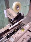 Used Bemis Semi-Automatic Uniform Top /Bottom Case Taper, Model 1018SA, carbon steel. Capable of speeds up to 28 CPM. Has side belt transfers and a case size range: length 4-1/2