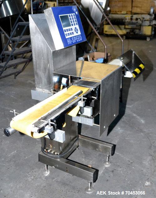 Used Garvens Model E2 Three Belt Checkweigher capable of speeds up to 200 containers per minute. Has a maximum weight range up to 600 grams. Has an air reject. 1/60/110V. Built 2004.