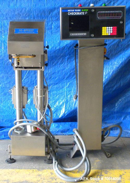Used Hi Speed Mettler Toledo Container Checkweigher, Model SST1100SS-CM. Stainless steel side belt load cell mechanism with a weight range up to 50 pounds. Capable of speeds up to 250 packages per mi...