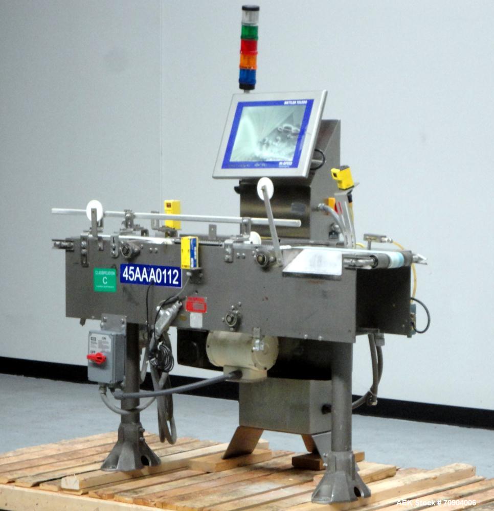 Used Mettler Toldeo XS Hi Speed Chain Checkweigher, Model CM9400-CM. Has the capacity to weigh up to 50 lbs., with a weigh pan length of 13". Currently set up to run 140 PPM, for carton size of 5.38"...