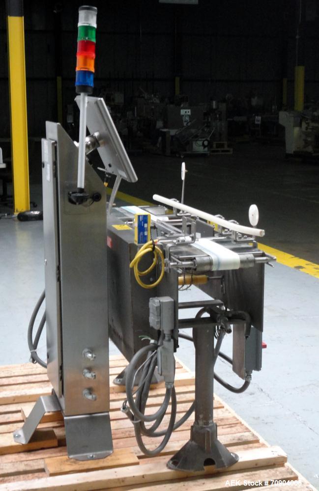 Used Mettler Toldeo XS Hi Speed Chain Checkweigher, Model CM9400-CM. Has the capacity to weigh up to 50 lbs., with a weigh pan length of 13". Currently set up to run 140 PPM, for carton size of 5.38"...