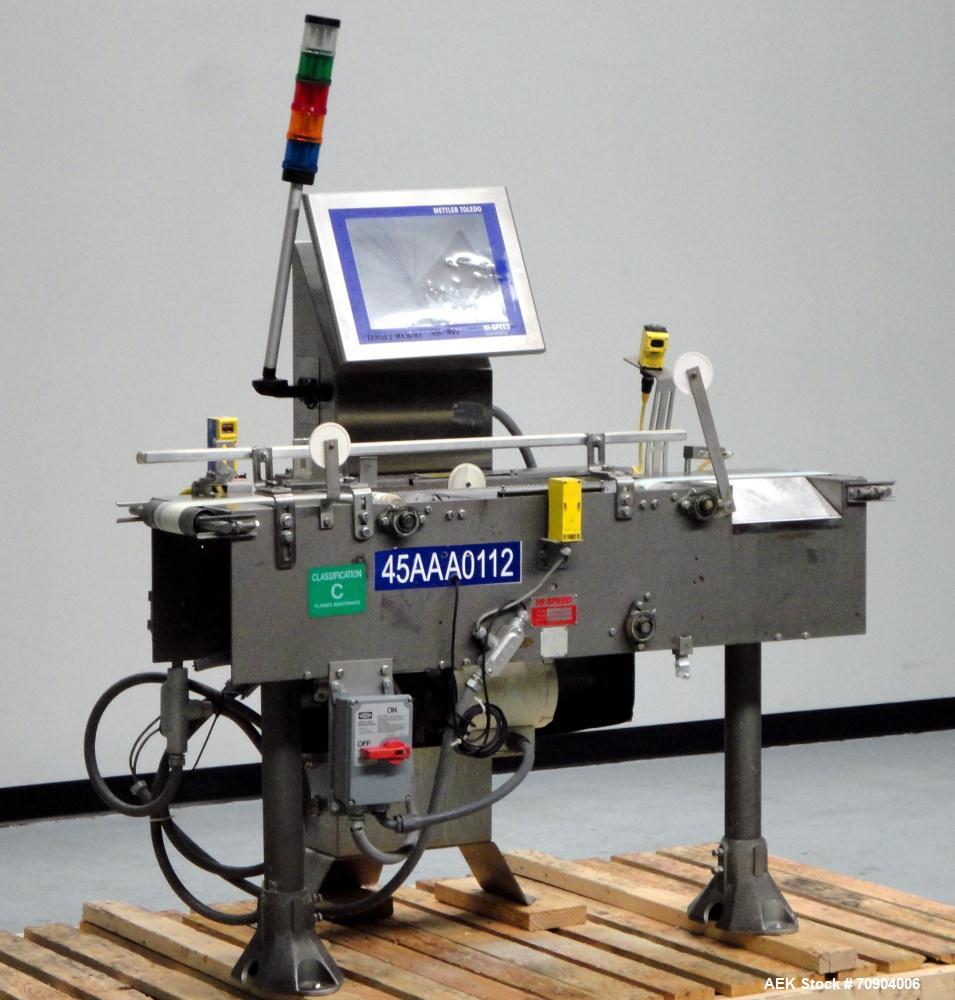 Used Mettler Toldeo XS Hi Speed Chain Checkweigher, Model CM9400-CM. Has the capacity to weigh up to 50 lbs., with a weigh pan length of 13". Currently set up to run 140 PPM, for carton size of 5.38"...