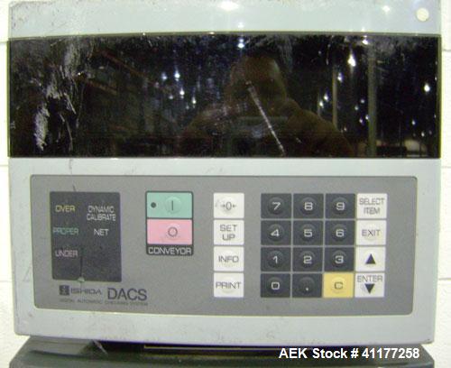 Used Ishida Checkweigher, Model DACS-W-050-SB/PB-I. Capable of speeds up to 130 PPM. Has a weight range from 50 to 5500 g. Has belt infeed and reject mechanism. Weighing accuracy: +/- 2.0 gram. Produ...