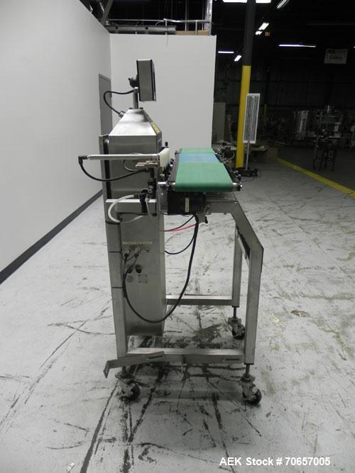 Used Lock Model Weigh Chek CK2500 Belt Checkweigher. Machine is capable of speeds up to 300 cases per minute (dependent on case size). Has a package weight range of 10 of 2500 g and a weight cell cap...