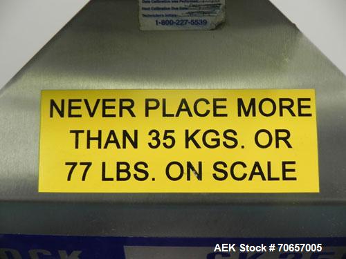 Used Lock Model Weigh Chek CK2500 Belt Checkweigher. Machine is capable of speeds up to 300 cases per minute (dependent on case size). Has a package weight range of 10 of 2500 g and a weight cell cap...