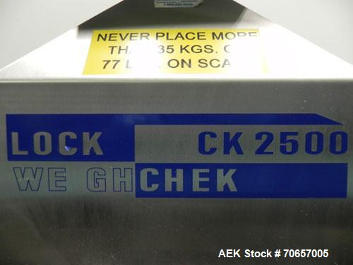Used Lock Model Weigh Chek CK2500 Belt Checkweigher. Machine is capable of speeds up to 300 cases per minute (dependent on case size). Has a package weight range of 10 of 2500 g and a weight cell cap...
