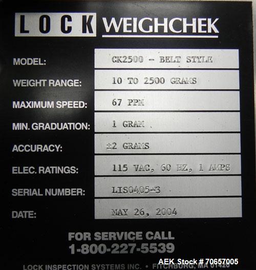 Used Lock Model Weigh Chek CK2500 Belt Checkweigher. Machine is capable of speeds up to 300 cases per minute (dependent on case size). Has a package weight range of 10 of 2500 g and a weight cell cap...