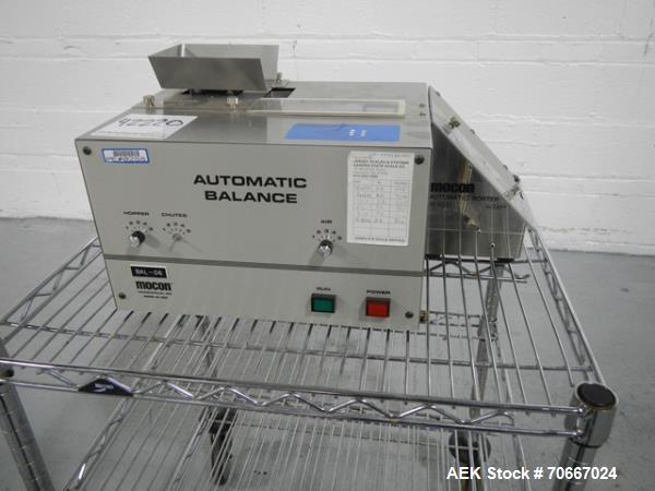Used Mocon Automatic Balance Checkweigher with Mocon automatic sorter, model AB-Plus Master, speeds from 20-45 units/minute, 1-0.1 mg readability, serial #0499AX065.