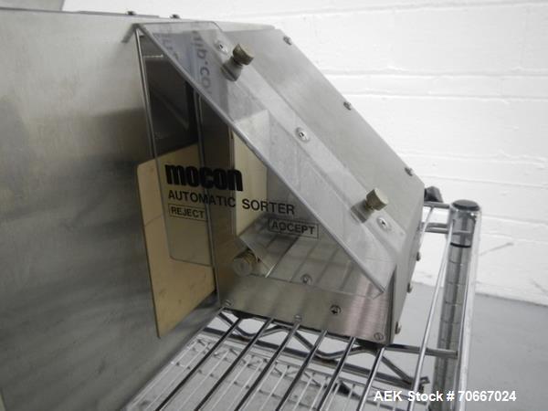 Used Mocon Automatic Balance Checkweigher with Mocon automatic sorter, model AB-Plus Master, speeds from 20-45 units/minute, 1-0.1 mg readability, serial #0499AX065.