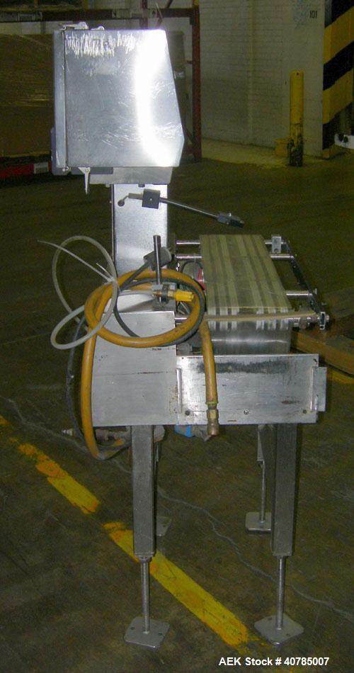 Used Ramsey Check Weigher, Model MK II/FR10/SS. 27" long x 7" wide mylar belt. Approximately 6 1/2" wide x 9" long weigh area.Includes control panel.Mounted on a stainless steel frame on 4 thread rod...