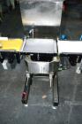 Used Garvens Model E2 Three Belt Checkweigher capable of speeds up to 200 containers per minute. Has a maximum weight range up to 600 grams. Has an air reject. 1/60/110V. Built 2004.