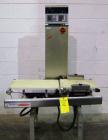 Used Ishida Checkweigher, Model DACS-W-050-SB/PB-I. Capable of speeds up to 130 PPM. Has a weight range from 50 to 5500 g. Has belt infeed and reject mechanism. Weighing accuracy: +/- 2.0 gram. Produ...