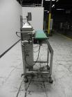Used Lock Model Weigh Chek CK2500 Belt Checkweigher. Machine is capable of speeds up to 300 cases per minute (dependent on case size). Has a package weight range of 10 of 2500 g and a weight cell cap...