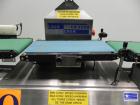 Used Lock Model Weigh Chek CK2500 Belt Checkweigher. Machine is capable of speeds up to 300 cases per minute (dependent on case size). Has a package weight range of 10 of 2500 g and a weight cell cap...