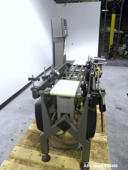 Used Hi-Speed Checkweigher, Model MM. Conveyor consists of8" wide x 12" long belt infeed, adjustable width plastic silent chain 9"L stationary, 10" long load cell and 14" wide staionary, 8" wide x 12...