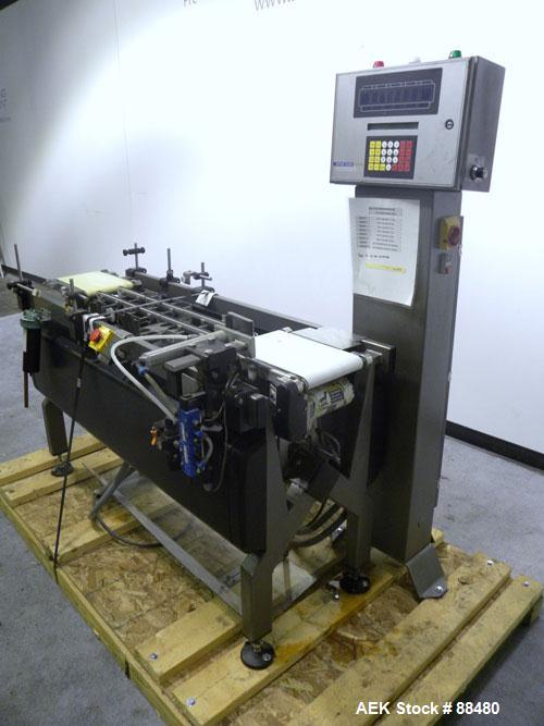Used Hi-Speed Checkweigher, Model MM. Conveyor consists of8" wide x 12" long belt infeed, adjustable width plastic silent chain 9"L stationary, 10" long load cell and 14" wide staionary, 8" wide x 12...