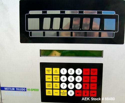Used Hi-Speed Checkweigher, Model MM. Conveyor consists of8" wide x 12" long belt infeed, adjustable width plastic silent chain 9"L stationary, 10" long load cell and 14" wide staionary, 8" wide x 12...
