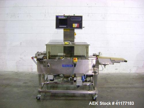 Used Hi-Speed Mettler Toledo Checkweigher, Model CM6400WD-CM. Stainless steel. Side belt driven infeed, and discharge. Approximate 36’’ chain weigh section, weight range up to 20 pounds. Capable of s...